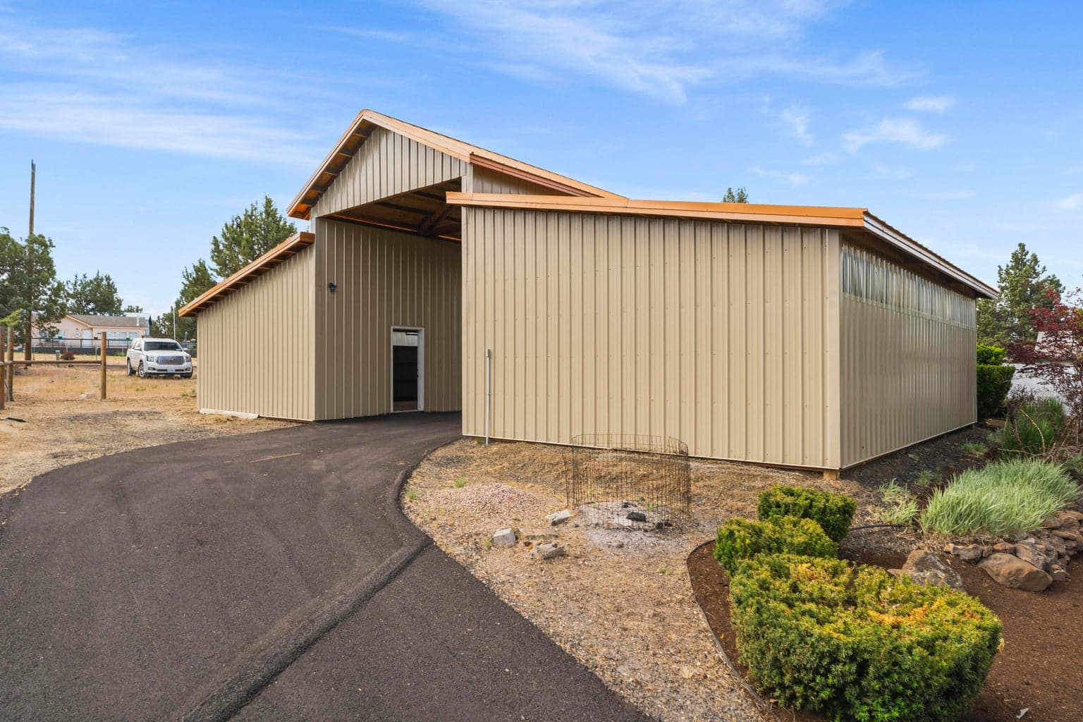 Paved circular driveway. back side of garages