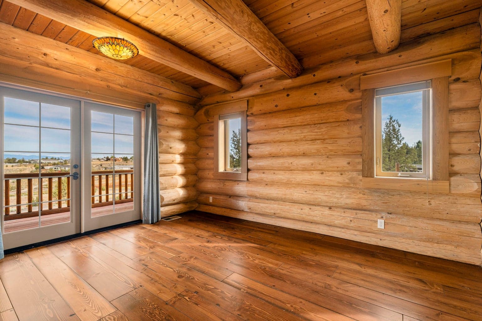 Primary bedroom with views and french doors to the deck - on the main
