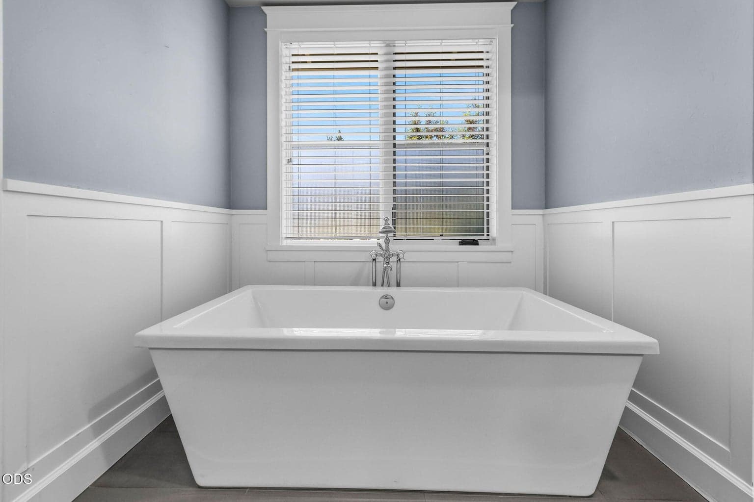 Serene soaking tub with polished fixtures, clean architectural trim, and a peaceful, spa-inspired feel.