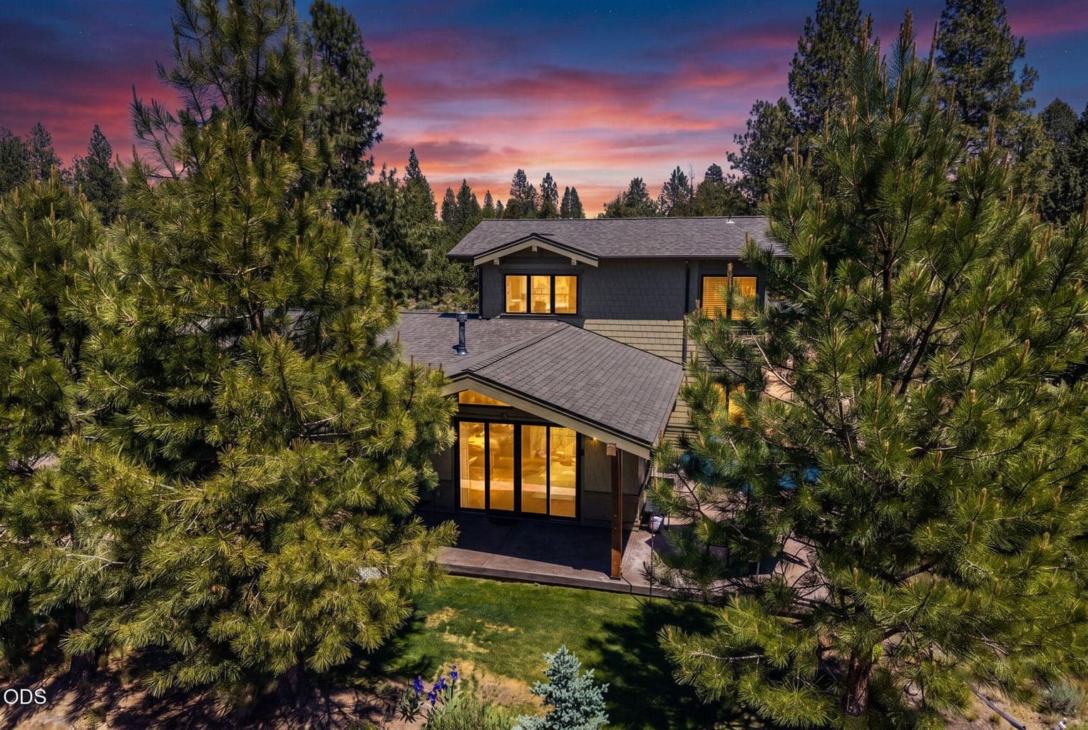 Northwest-inspired architecture with stone, cedar-style detailing, mature trees, and thoughtfully landscaped outdoor spaces.