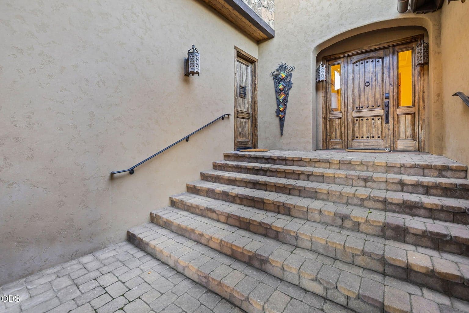 Thoughtfully designed, the paver courtyard offers a gracious approach to both the main residence and private guest accommodations.