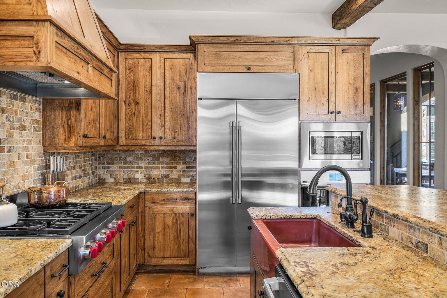 Designed for culinary excellence, the chef’s kitchen includes new GE Café appliances, Wolf gas cooktop, full-height tile backsplash, and a built-in Miele coffee system