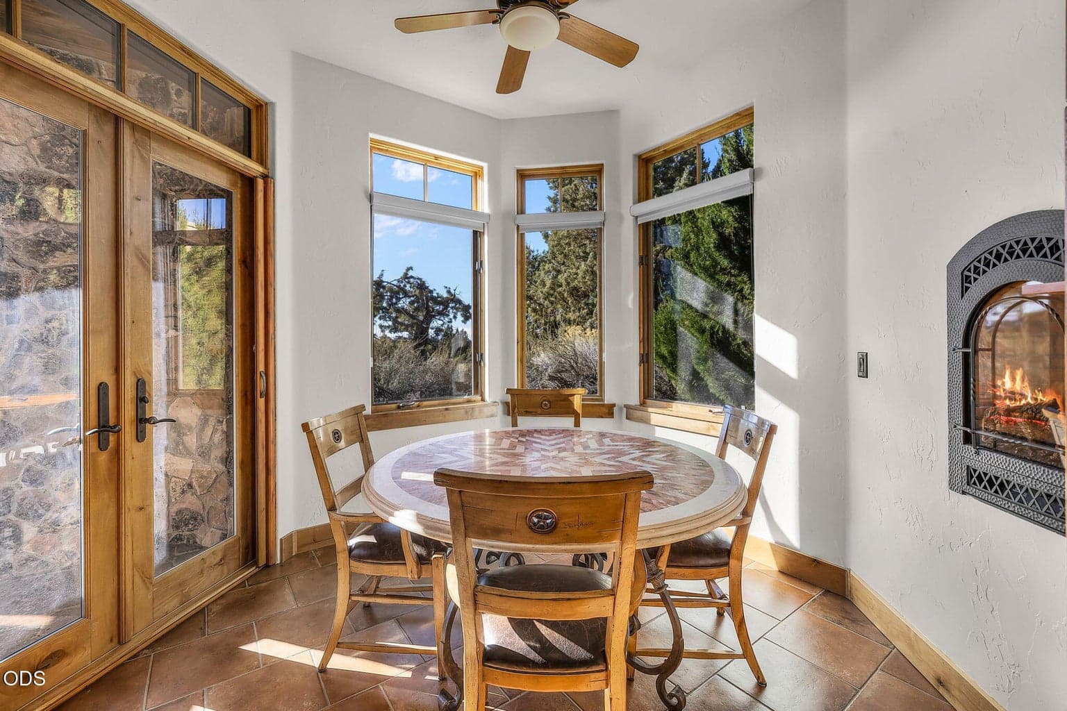 Enjoying views of the Fazio golf course and Cascade Mountains, the breakfast nook offers a gas wall fireplace for cozy ambiance and opens directly to the rear patio.