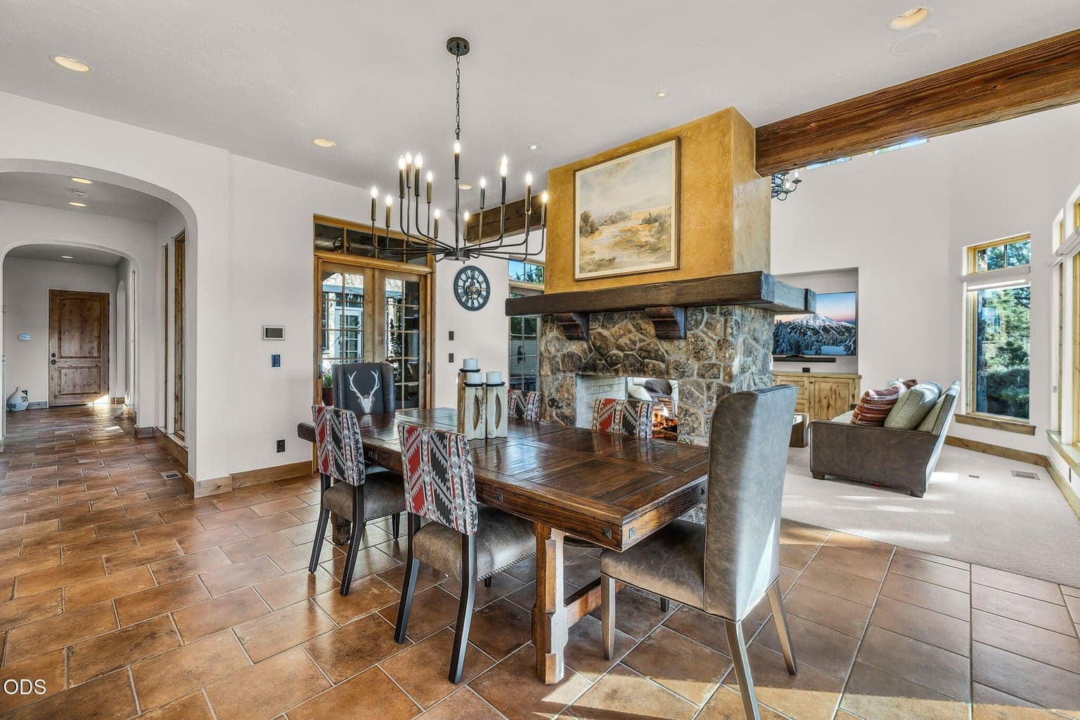 Elegant dining with gorgeous solid wood long dining table and custom dining chairs set the mood for an entertainment.