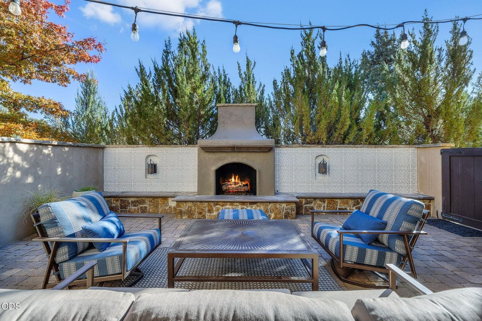 A striking large fireplace defines the courtyard as its focal point, delivering an inviting, elevated setting for entertaining.