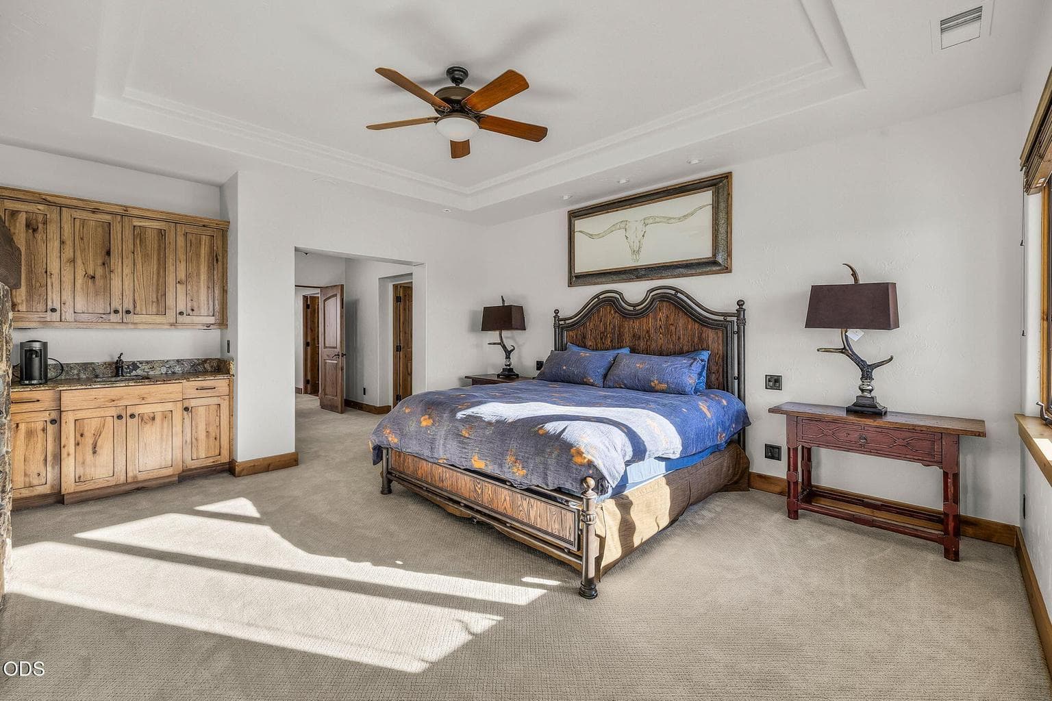 A wet bar and coffee bar with extra storage complete the primary bedroom