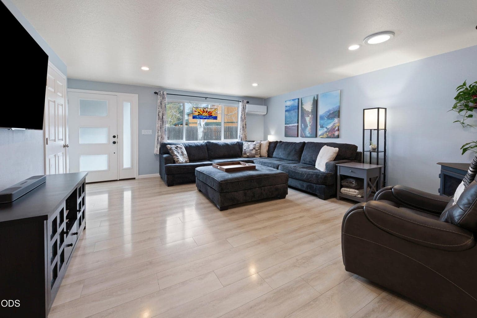 Great room of main home with wood burning fireplace