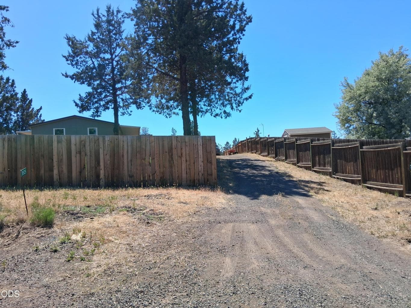 Front of property with fenced front yard and driveway upto the house