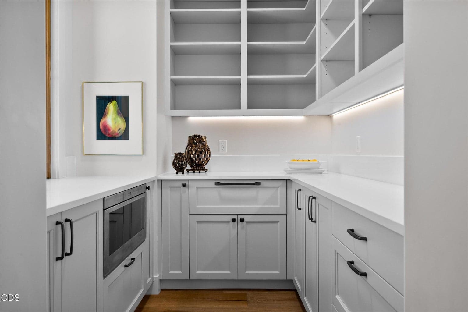 Hidden butler's pantry houses the microwave and plenty of storage