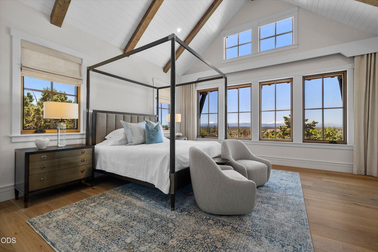 The primary bedroom is framed around stunning, panoramic Cascade Mountain views