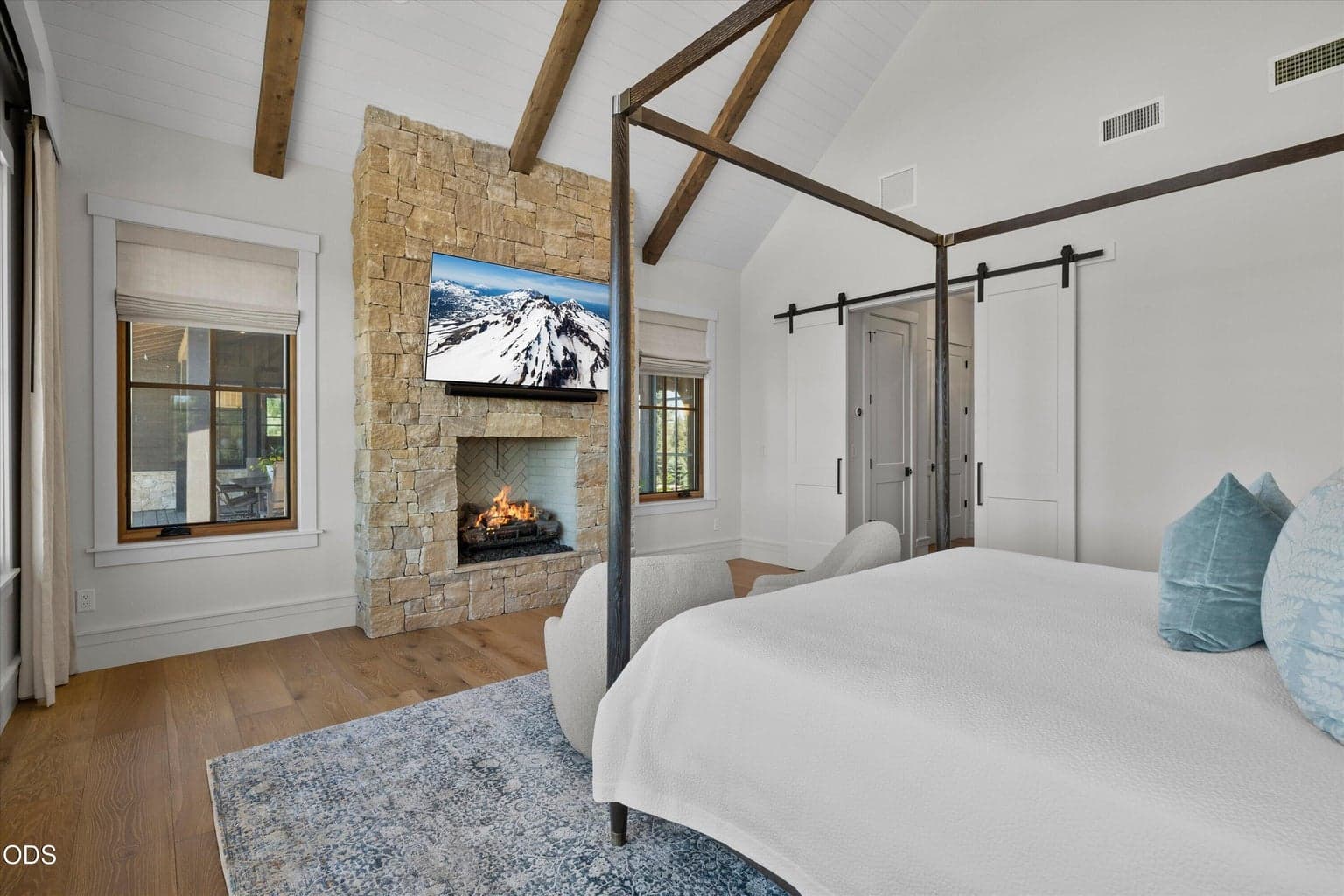 Another custom stone and gas fireplace in the primary bedroom