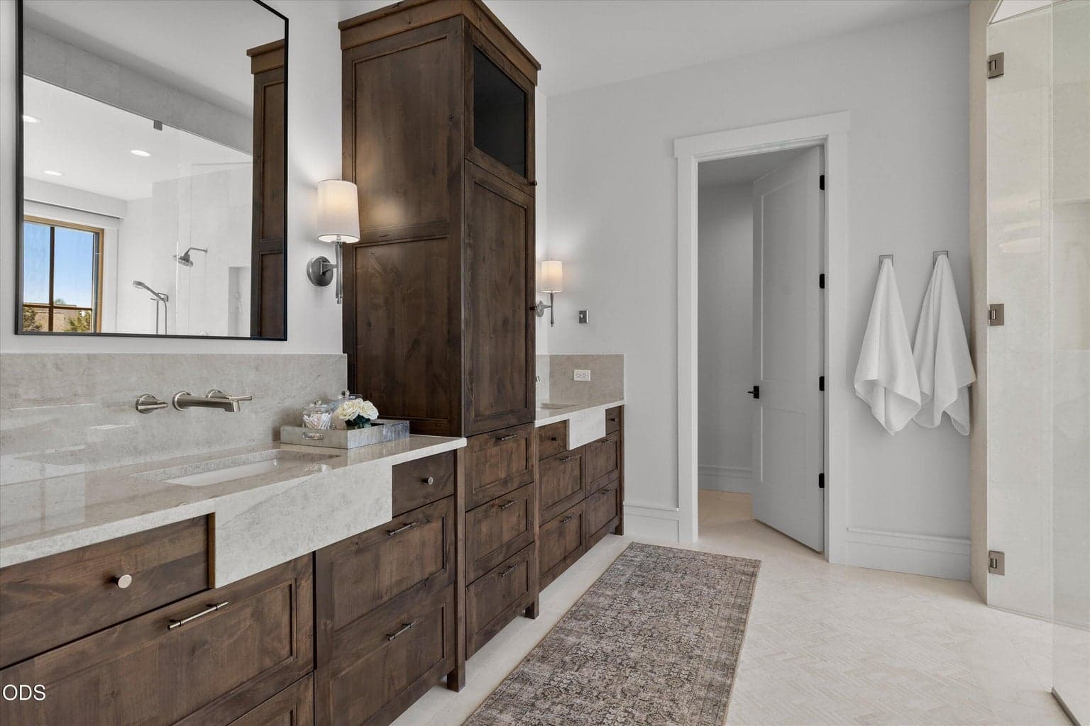 Luxurious primary bathroom with double vanity and water closet