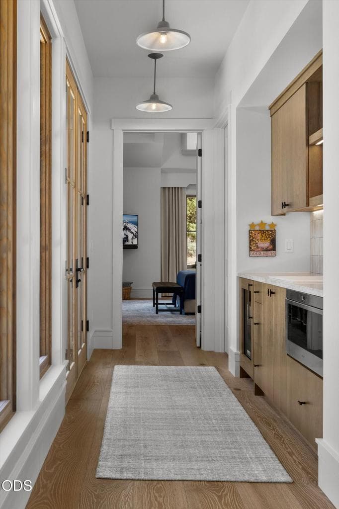 The two guest suites can be locked from the rest of the house for an attached ADU living or staying option. Hallway doors open to the front courtyard. The wetbar features a sink, microwave, and refrigerator.