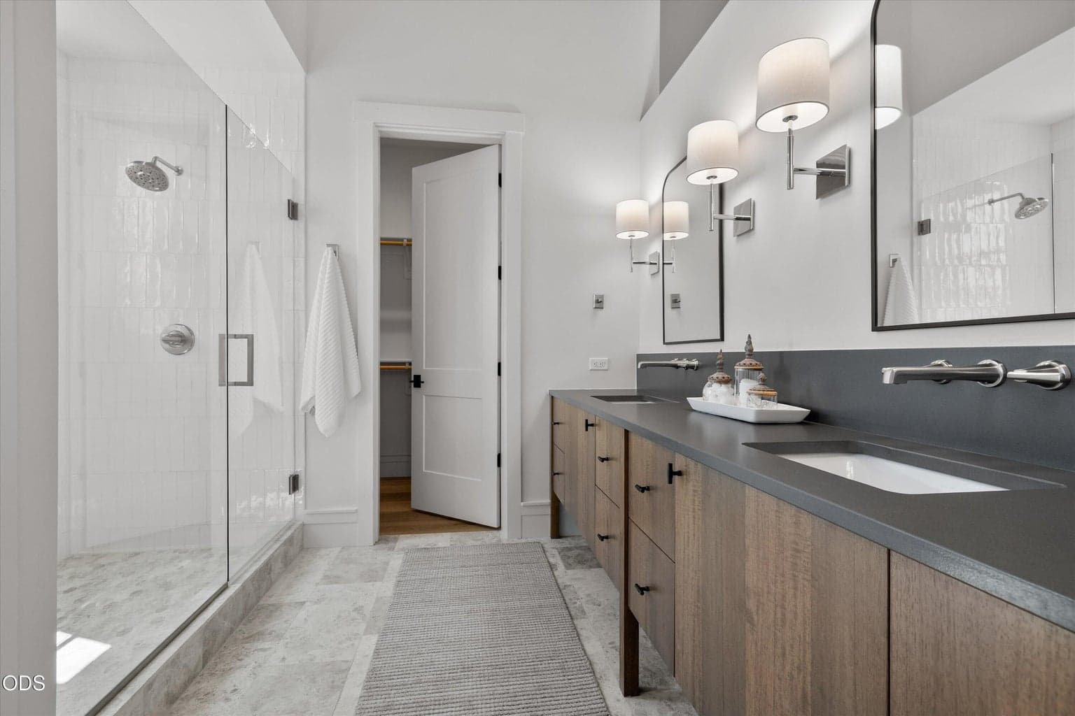 One guest suite bathroom includes a double vanity, walk-in shower, water closet, and walk-in closet