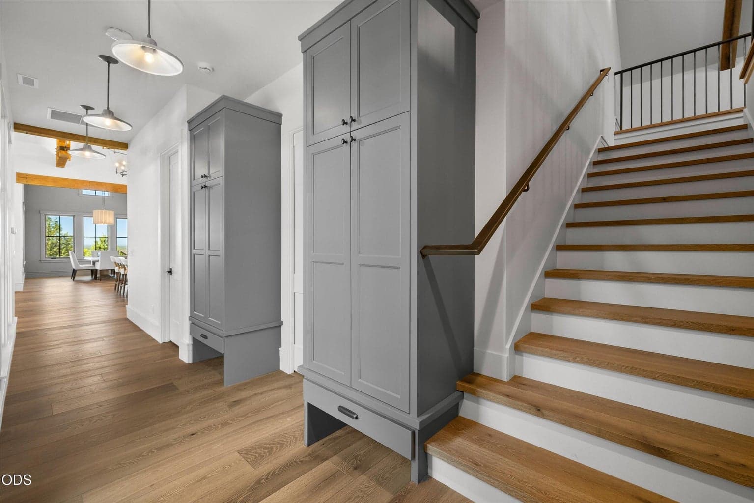 Mud-room style utility storage in the hallway. Staircase leading to bonus room