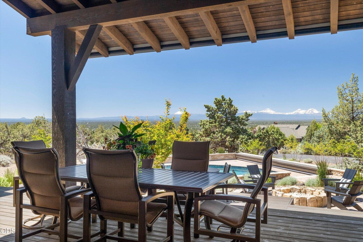 Covered back porch with space for dining, cooking, lounging, entertaining, and more