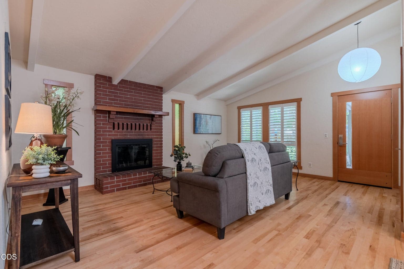 Living area is anchored by a wood-burning fireplace.