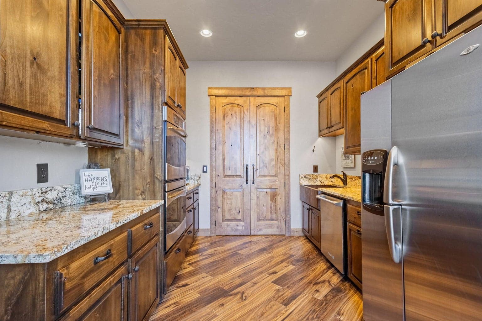 Butlers pantry w/ additional fridge, dishwasher, ovens, sink and pantry.