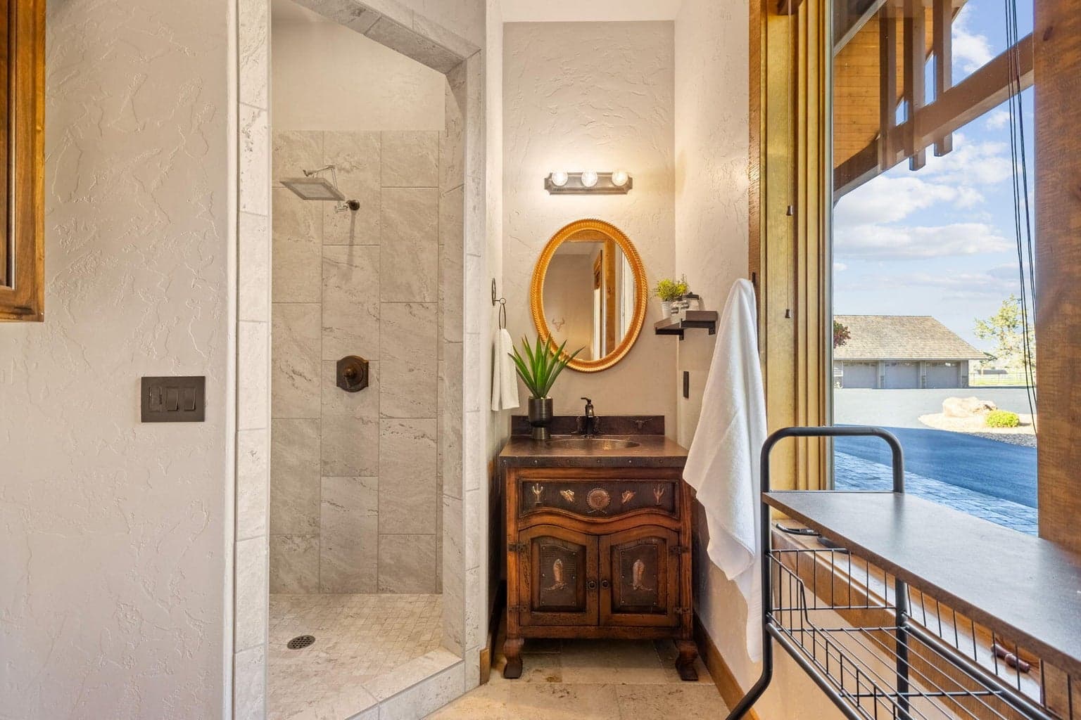 Ensuite bathroom in bedroom 3 with walk in tile shower and custom vanity.