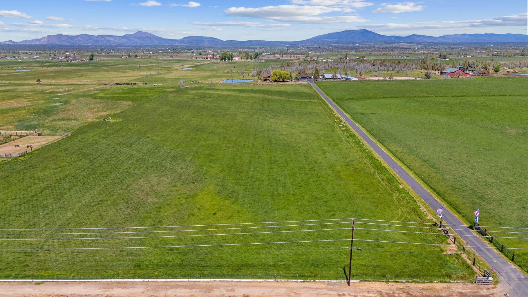 Main home is tucked back at the end of a long paved driveway.