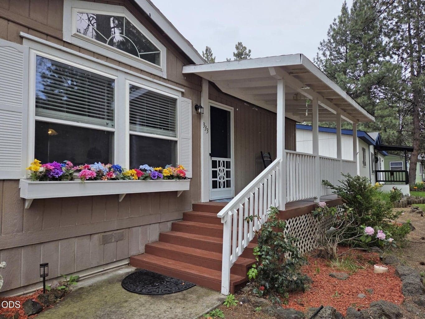 Welcome home, freshly painted covered front porch with new screen door.