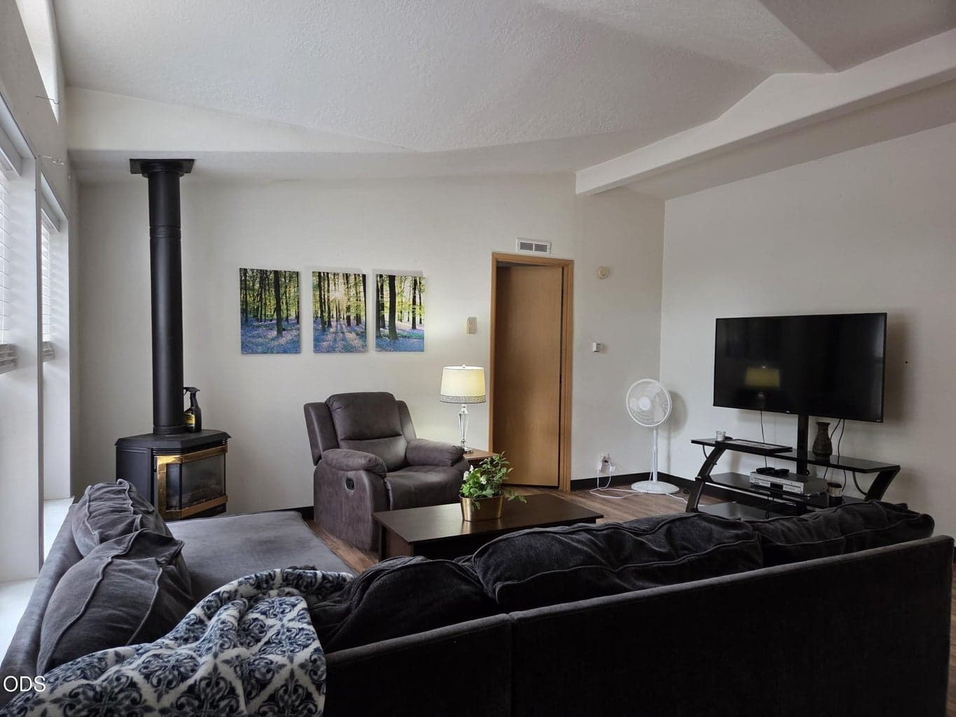 Comfortable living room with vaulted decorative ceilings.