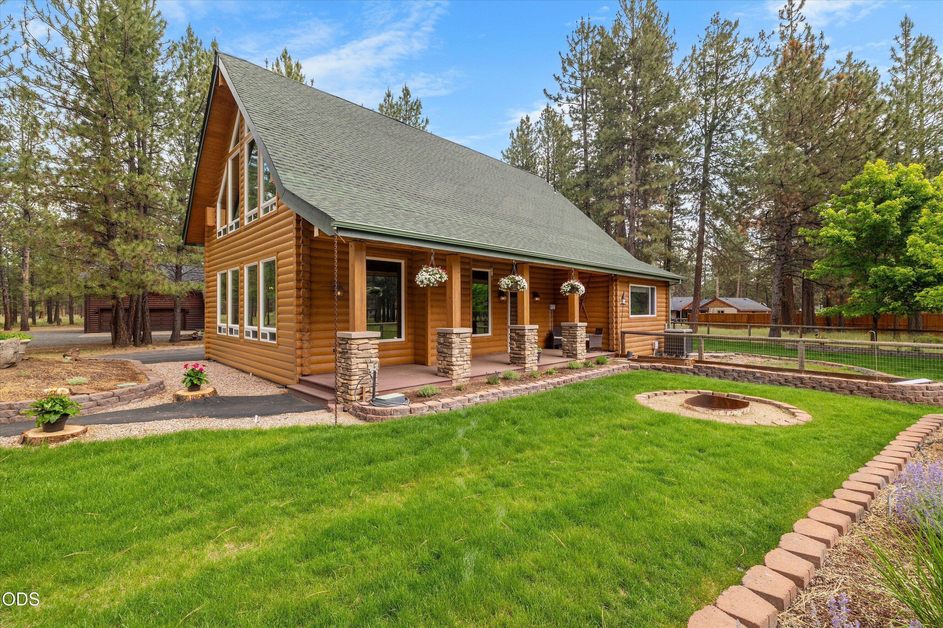 Beautiful yard along covered entrance to home.