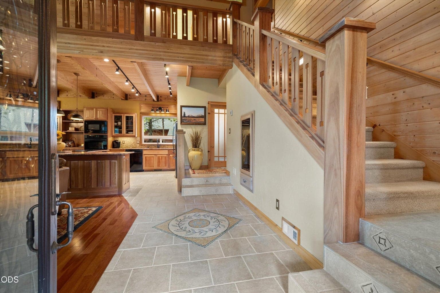 Welcoming entry features custom tile mosaic and millwork accents.