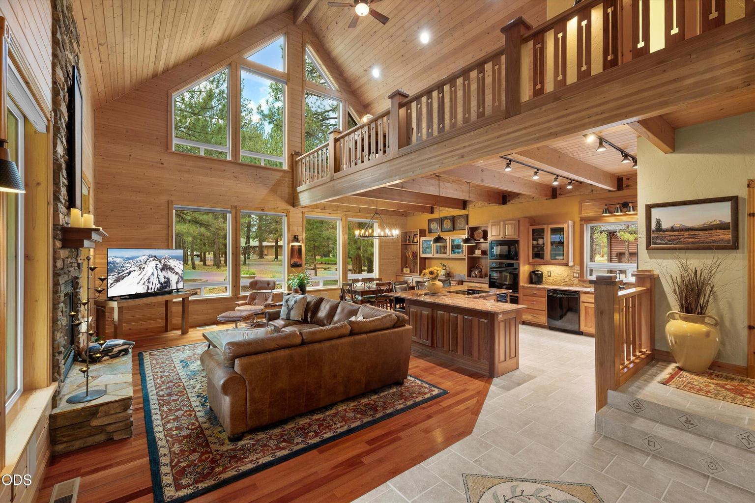 Ceilings soar up two stories from the entry and frame the majestic outdoors