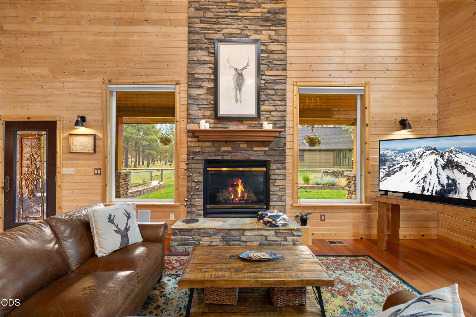 Great room is cozy and well-lit with wonderful sconces and a spacious layout.