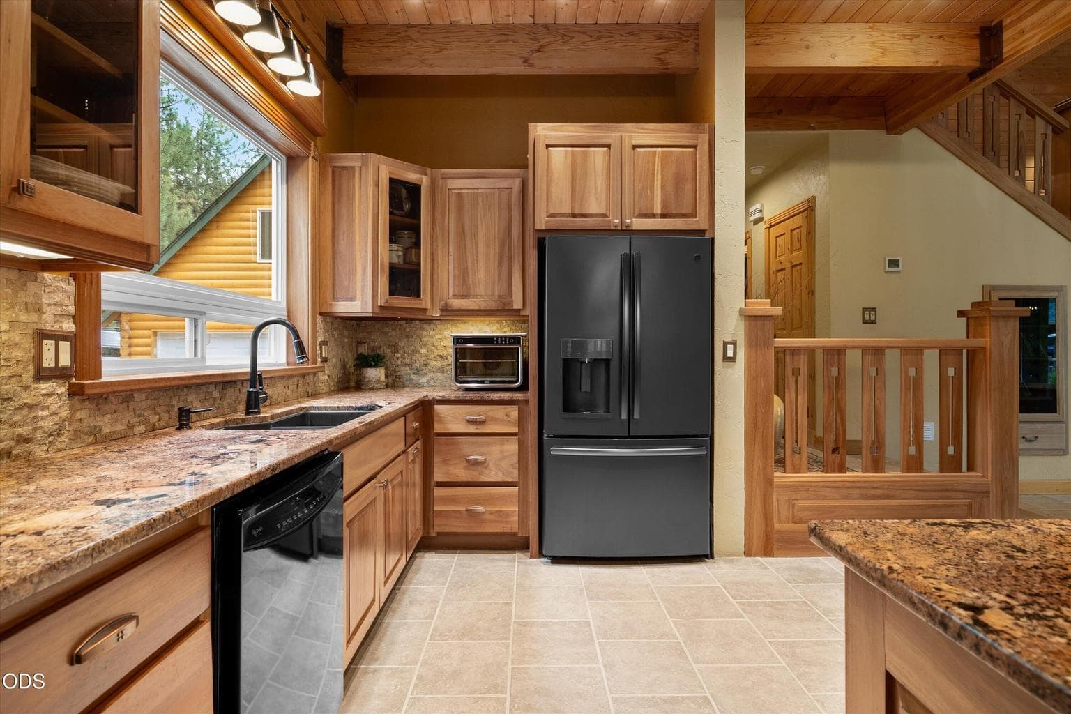 Granite counters and custom Lypta wood cabinets throughout the kitchen and dining area,