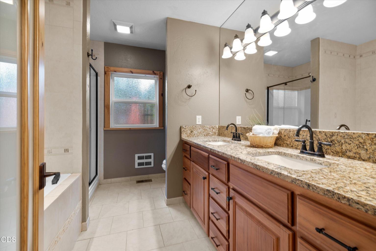 Large ensuite with dual sinks, soaking tub and shower.
