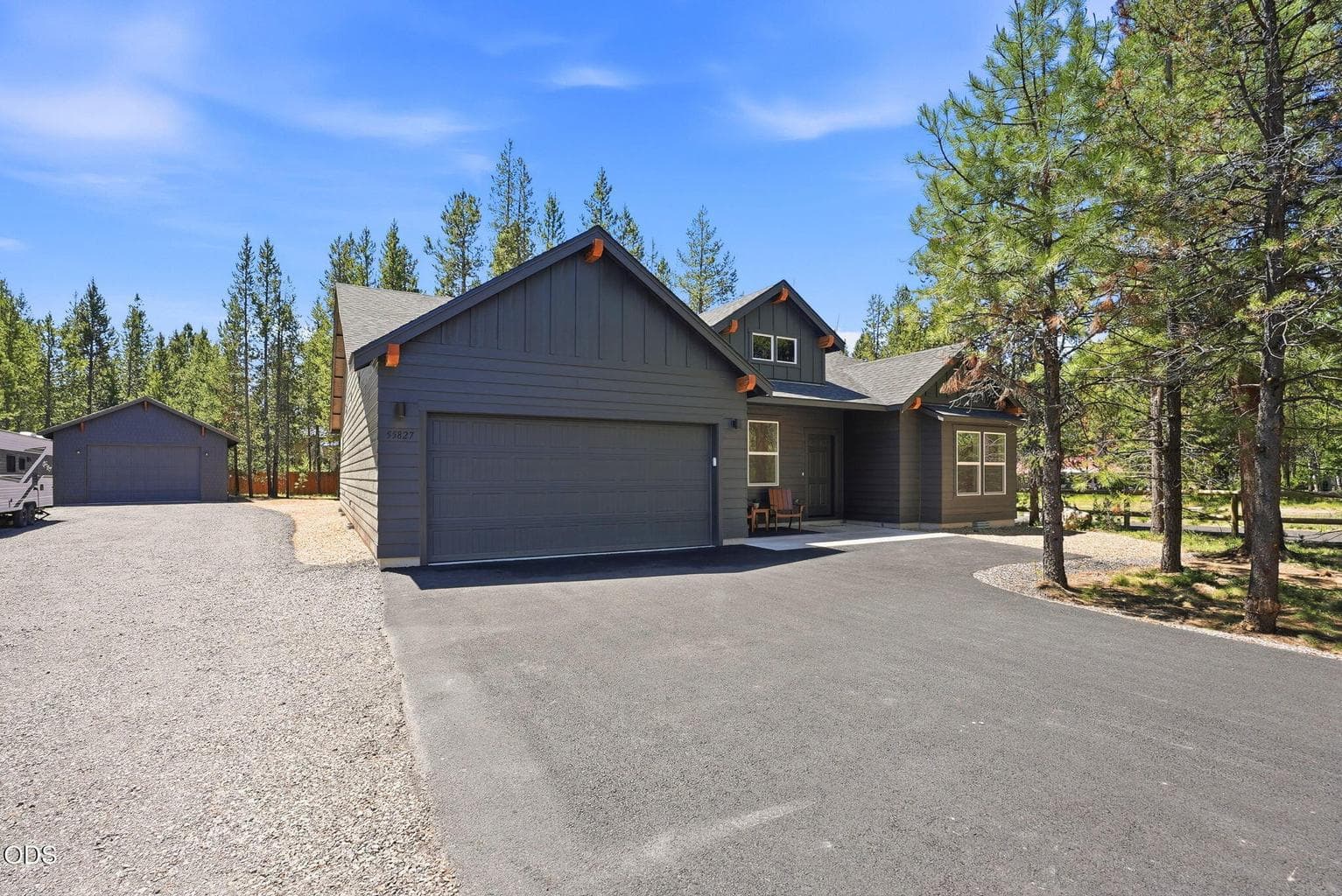 Spacious driveway leads to detached shop.