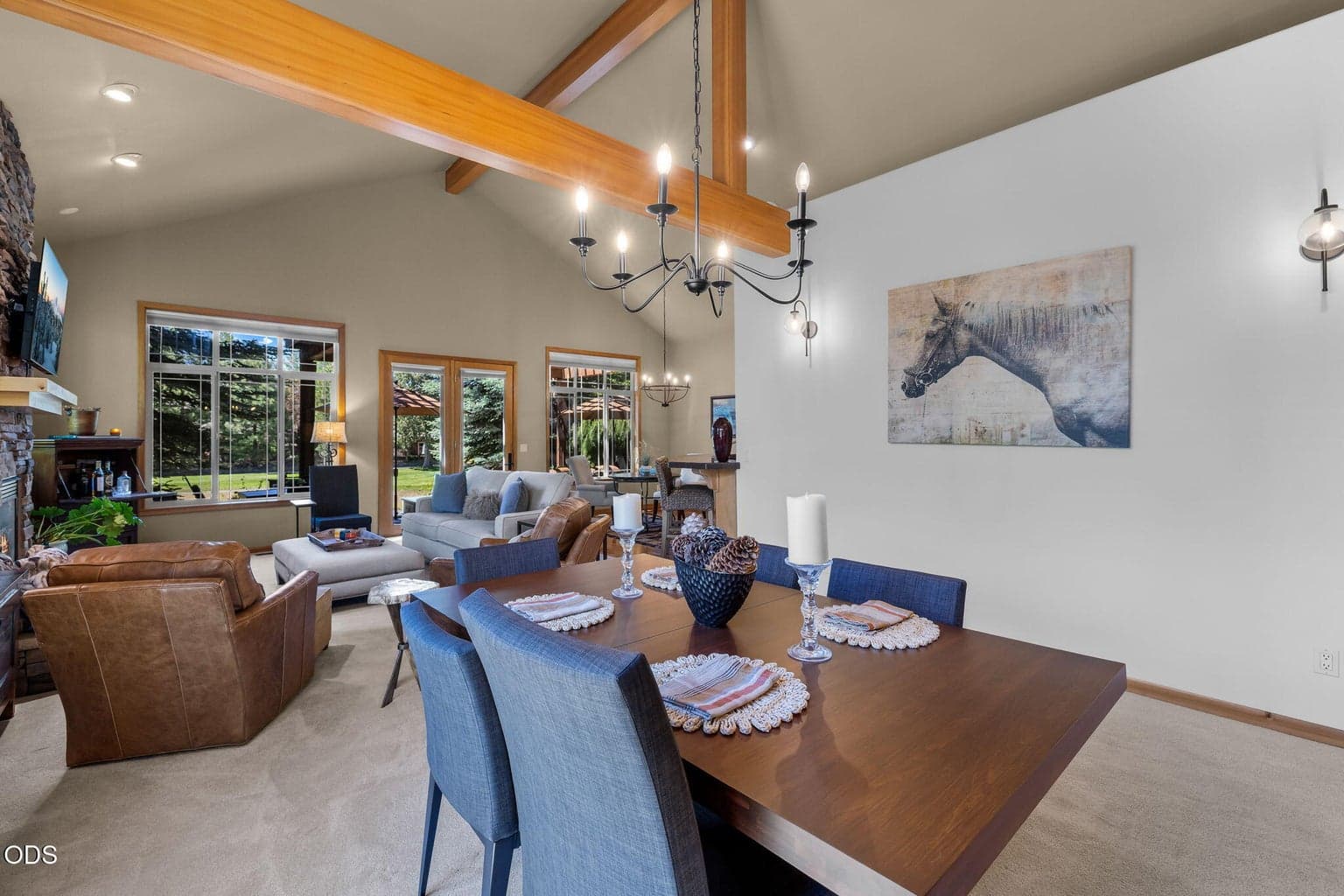 Gracious entry opens to vaulted living spaces with warm wood trim, slate flooring and natural light.
