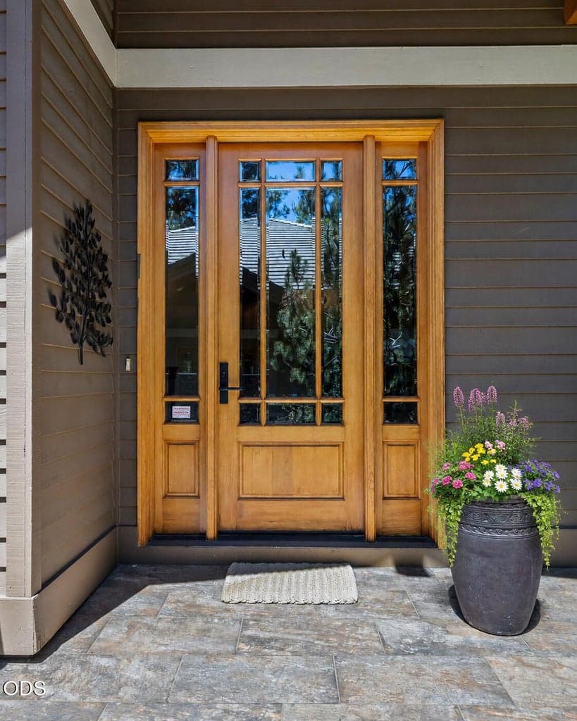 Welcoming front approach with paver walkway, stone accents and beautifully maintained landscaping.