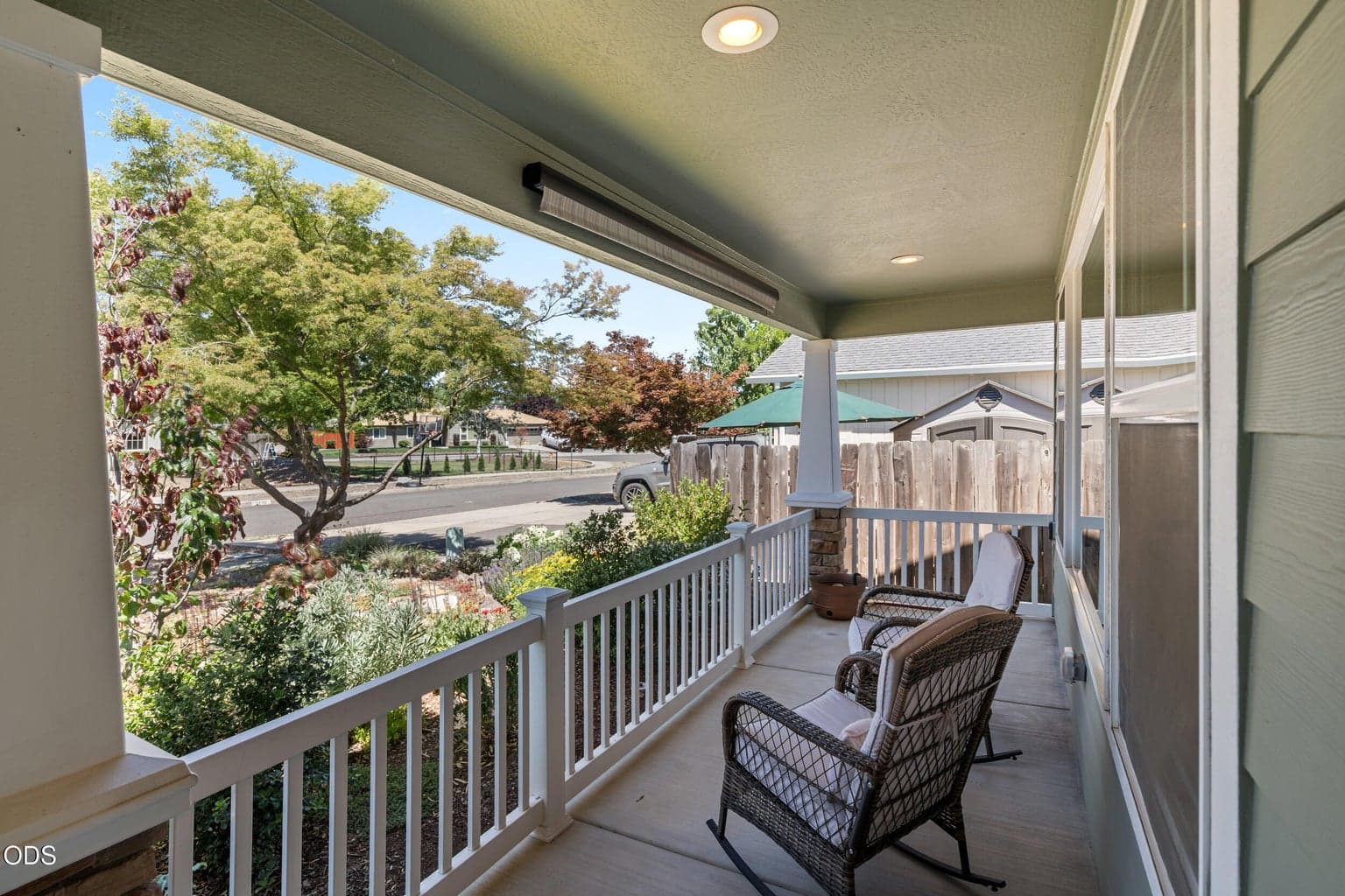 covered front porch with remote shade for hot afternoons