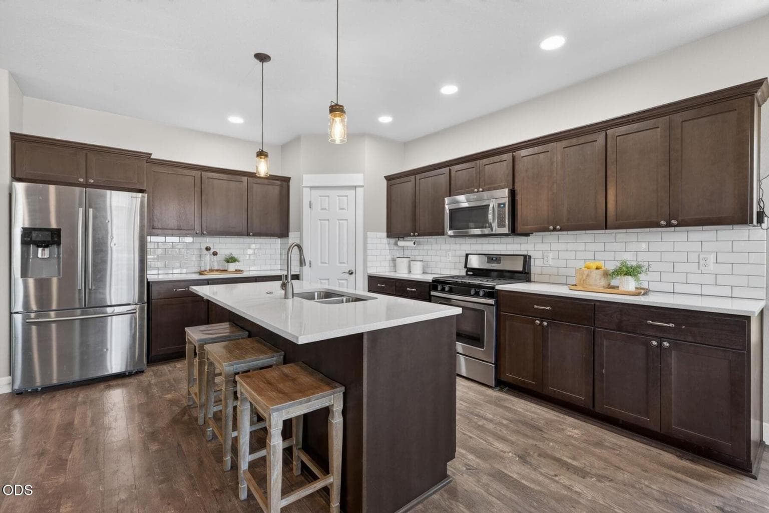 Expansive kitchen with warm wood and light solid surfaces