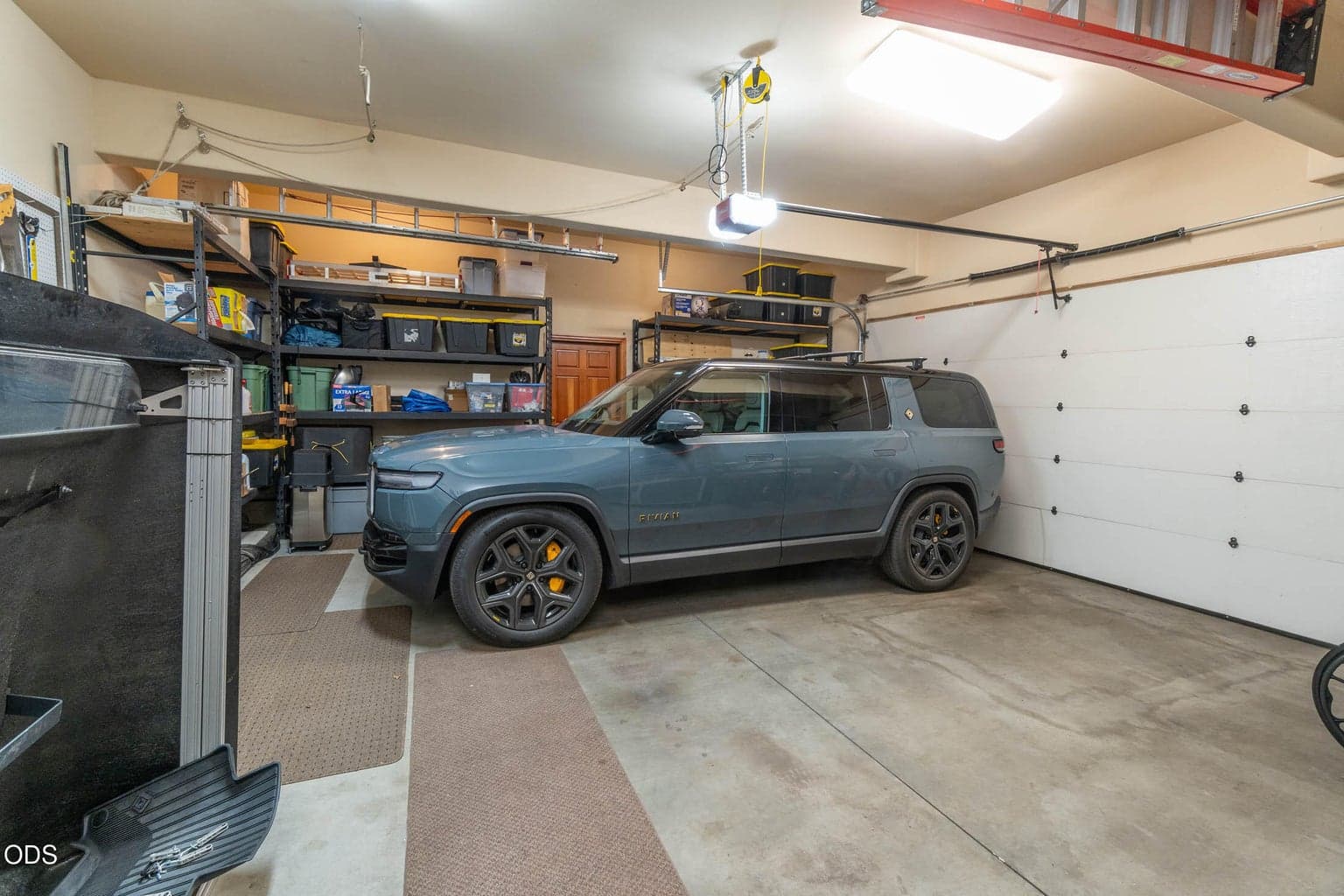 636 sq. ft. Garage with storage cabinets, shelves, a chest freezer and access into the flex room / golf training center