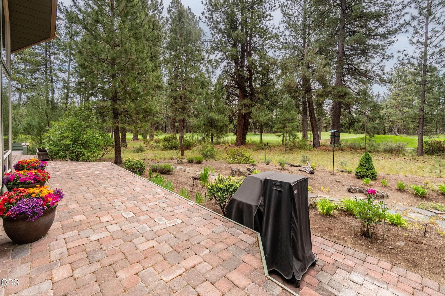Photo of the rear paver deck from the sunroom door towar the 12th fairway.