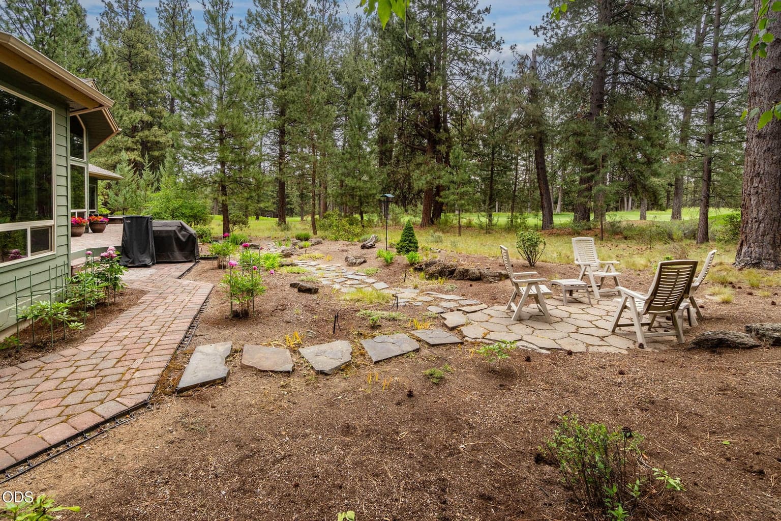 Pavers around the entire rear of home with separate entries into the suynroom, living room and primary bedroom into the spa deck