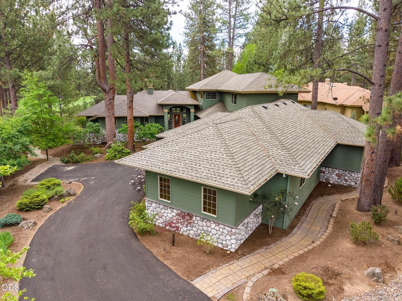 Overhead drone view of the entryway into this beautiful home