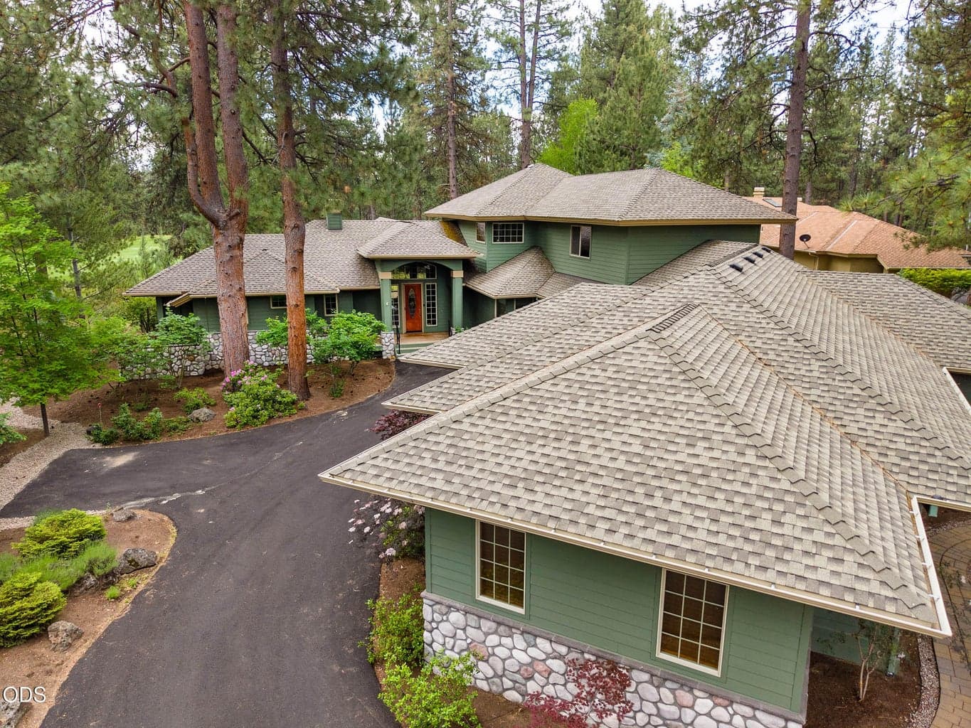 Drone view of the flex room in the foreground and front door entry to the back
