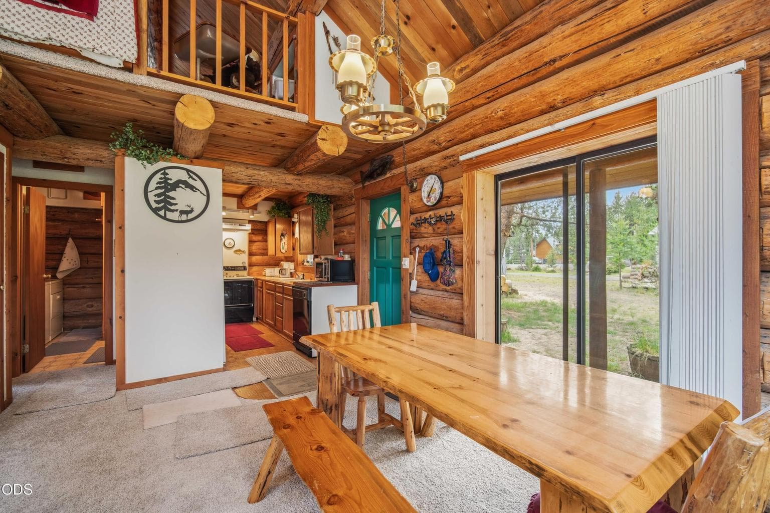 The dining area connects easily with the kitchen and outdoor deck, supporting relaxed meals and uncomplicated cabin living.