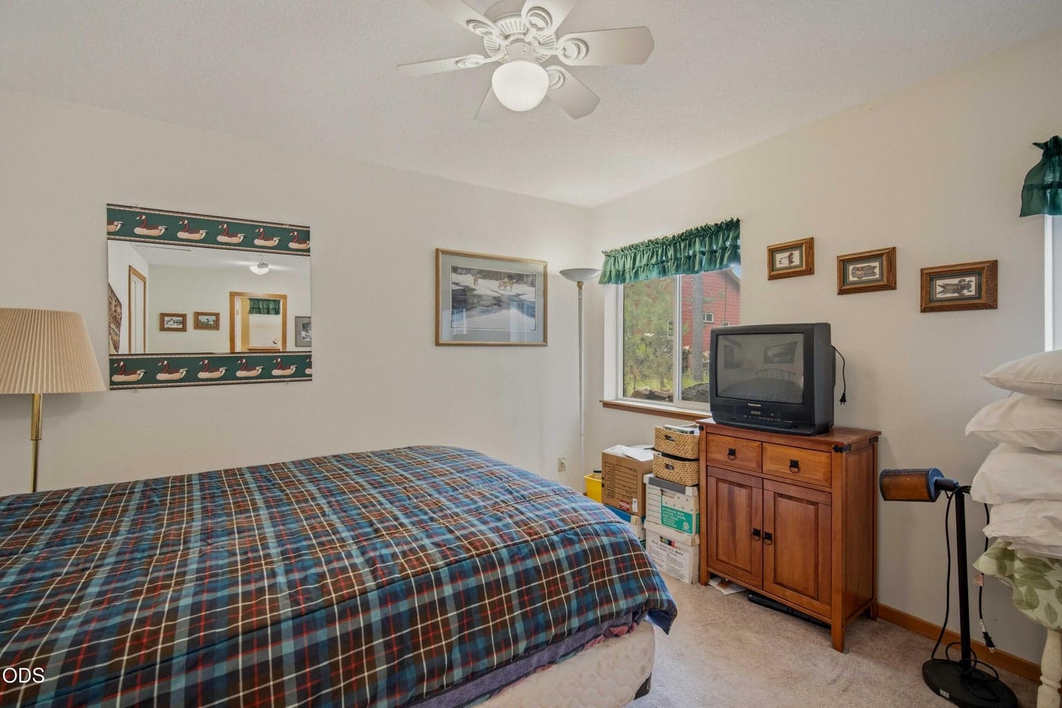 A second view of the conditioned guest bedroom shows its windows, ceiling fan, and comfortable separation from the main cabin.