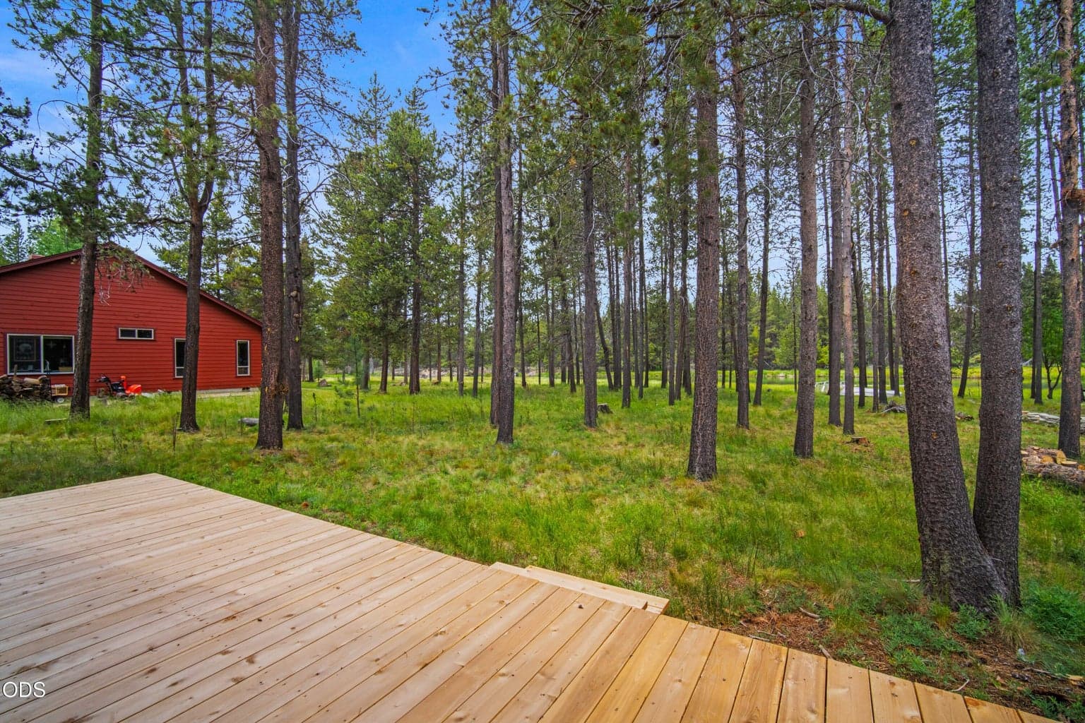 Newly replaced decks link the log cabin, garage area, and conditioned guest bedroom and bathroom into one connected retreat.