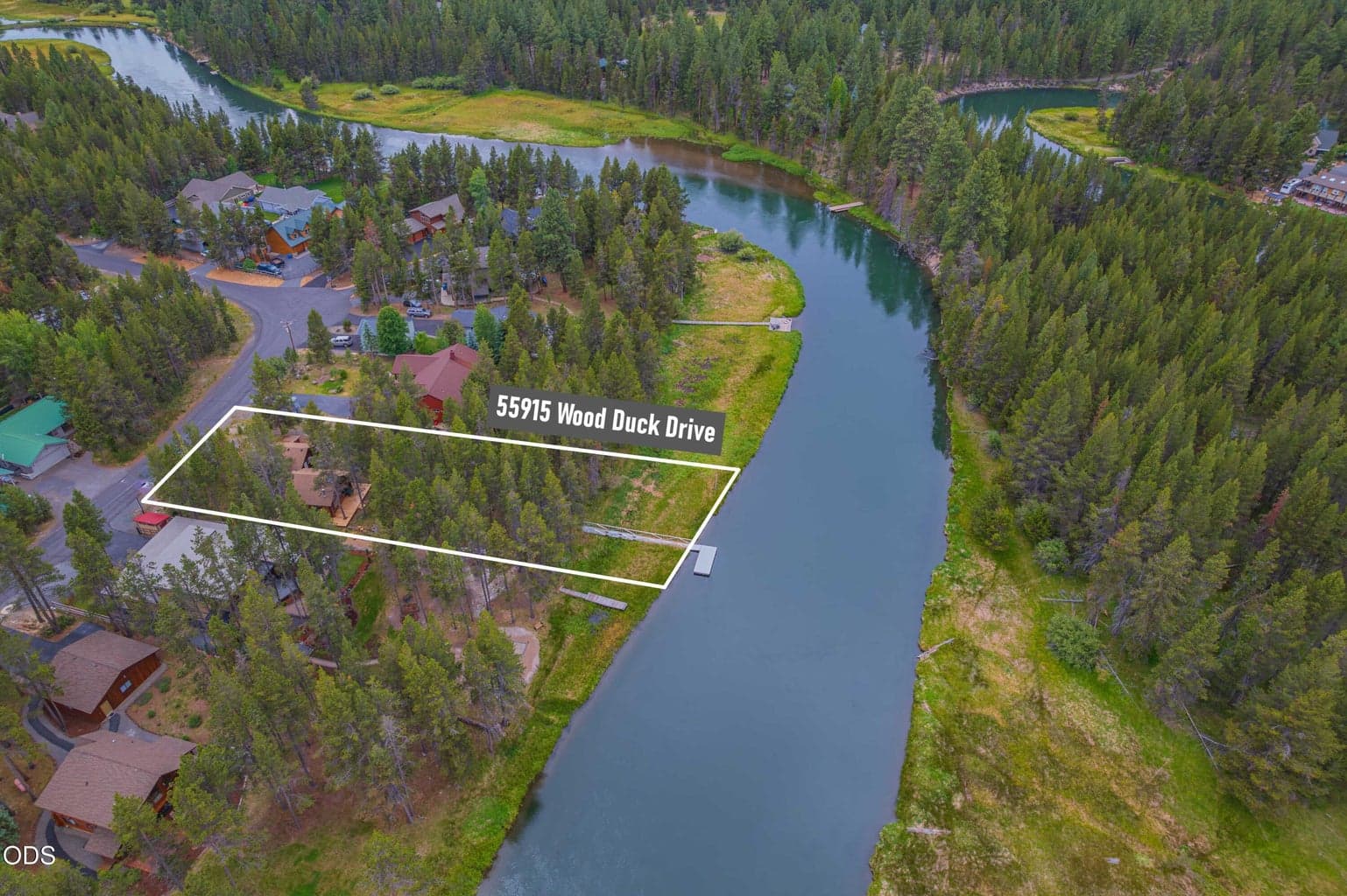 The labeled aerial identifies the approximate property boundaries and shows the direct relationship between 55915 Wood Duck Drive and the Big Deschutes River.