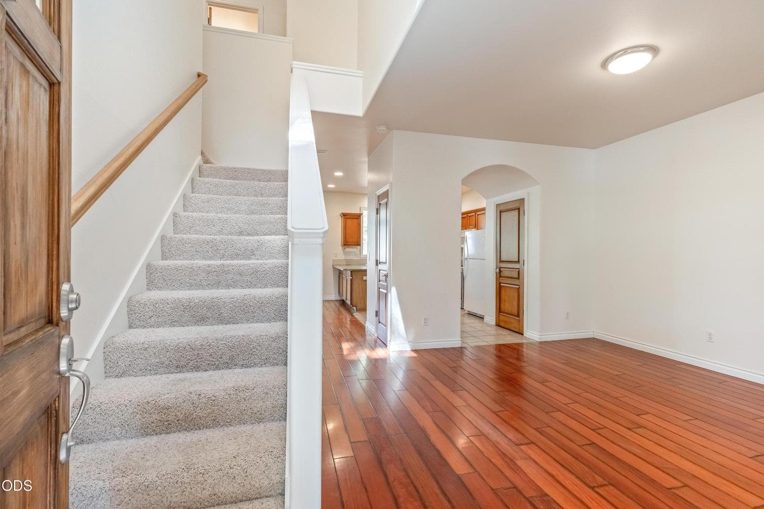 Open entry to stairs and living room or formal dining area