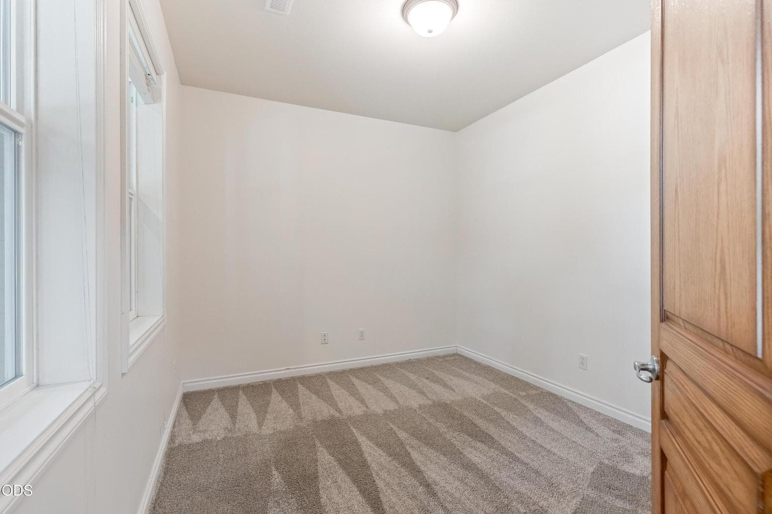 Downstairs room just off the entry overlooks front porch and yard. It has a large closet and would make a wonderful office or main level bedroom.