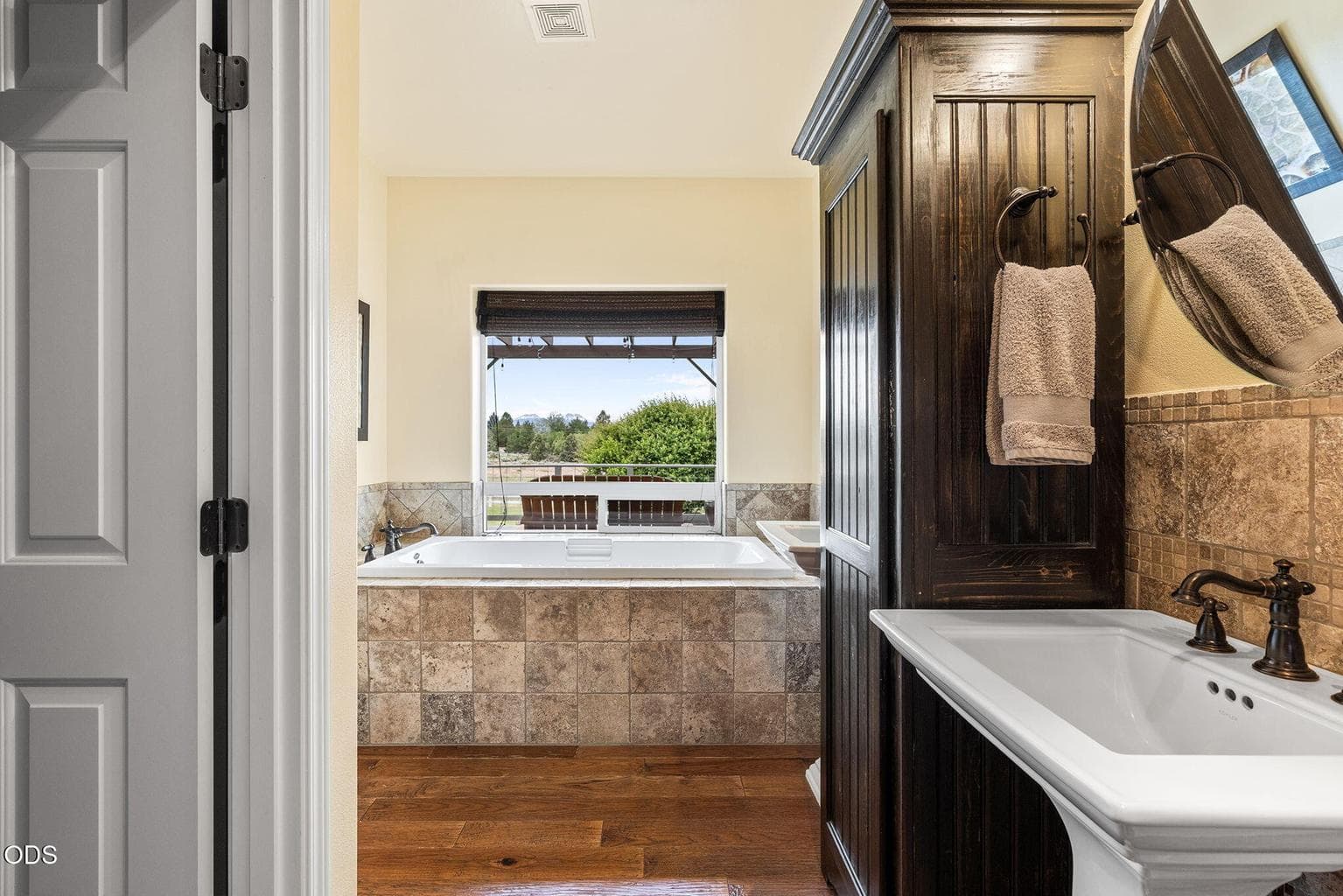 Main-floor primary bathroom with dual vanities