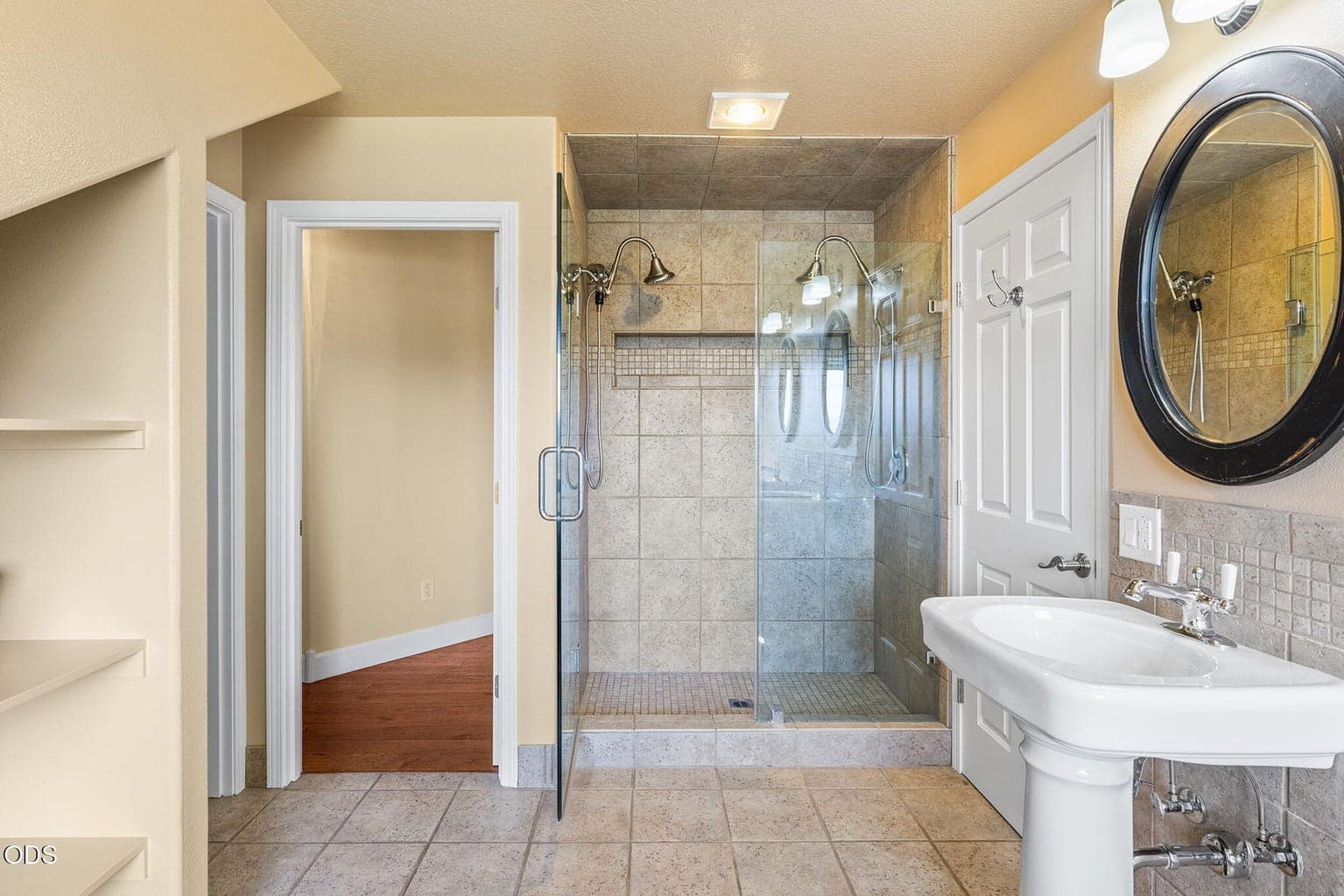 Upstairs Primary Bathroom with dual vanities and tile walk-in shower